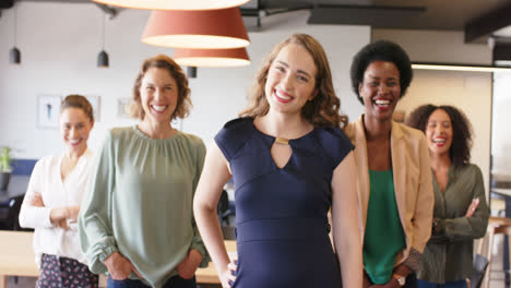 Portrait-of-happy-diverse-businesswomen-standing-in-office-smiling-to-camera,-in-slow-motion