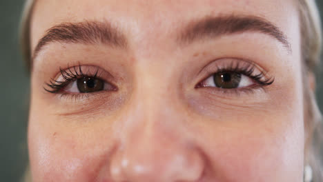 Close-up-portrait-of-caucasian-young-woman's-beautiful-eyes-in-yoga-studio