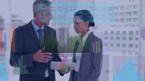 Animation-of-data-processing-over-diverse-businessman-and-businesswoman-discussing-at-office