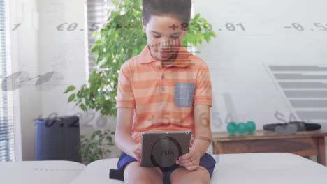 Animation-of-graphs-and-currency-signs-over-biracial-boy-using-digital-tablet-while-sitting-on-sofa