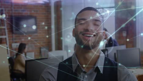 Animation-of-network-of-connections-over-portrait-of-biracial-businessman-smiling-at-office