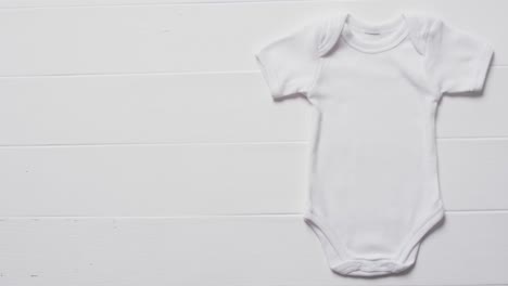 Video-of-white-baby-grow-with-copy-space-on-white-background