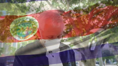 Animation-Des-Schwenkens-Der-Costa-Rica-Flagge-Gegen-Einen-Kaukasischen-Mann-Mit-Gesichtsmaske,-Der-Auf-Der-Straße-Hustet