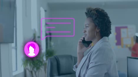 Chat-icon-and-speech-bubble-over-african-american-casual-businesswoman-on-phone-in-office