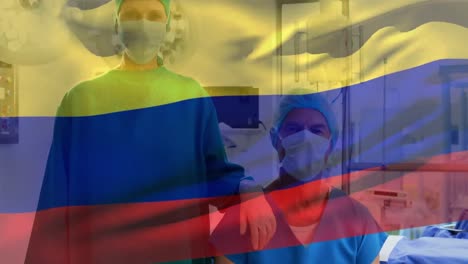 Animación-De-Ondear-La-Bandera-De-Colombia-Contra-El-Retrato-De-Un-Cirujano-Masculino-Y-Femenino-Caucásico-En-El-Hospital