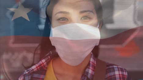 Animation-of-waving-chile-flag-against-portrait-of-asian-woman-wearing-face-mask-on-the-street