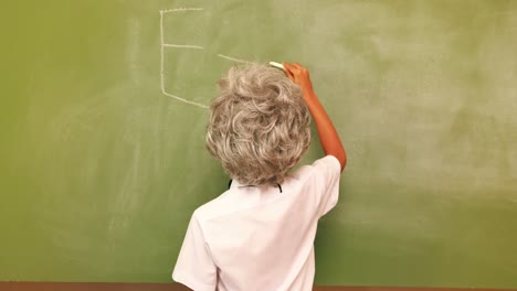 Cute-pupil-writing-maths-on-chalkboard
