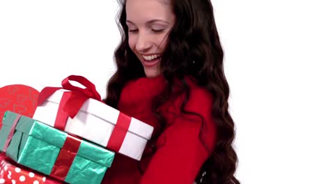 Festive-brunette-carrying-pile-of-gifts