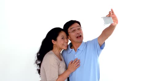 Couple-taking-selfie-and-grimacing