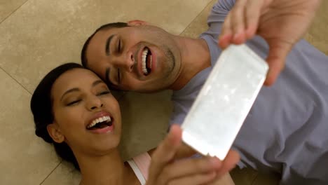 Smiling-young-couple-taking-selfies