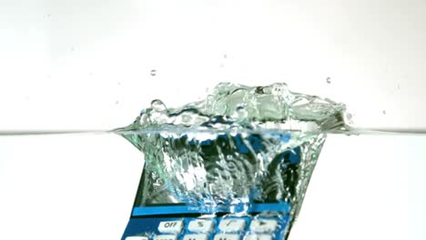 Blue-calculator-falling-into-water
