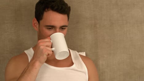 Schöner-Mann,-Der-Auf-Dem-Bett-Sitzt-Und-Kaffee-Trinkt