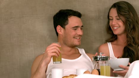 Pretty-smiling-couple-eating-breakfast