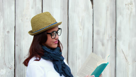 Smiling-hipster-woman-reading-a-book