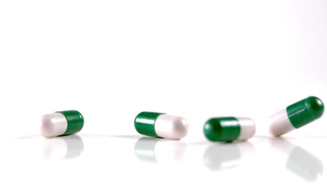 Lot-of-white-and-green-medication-falling