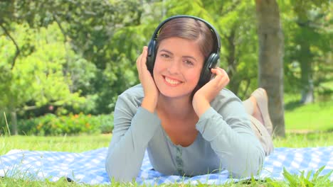 Young-woman-listening-to-music-outside