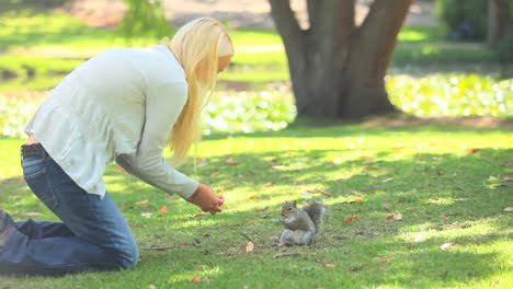 Young-woman-feeding-a-squirrel-