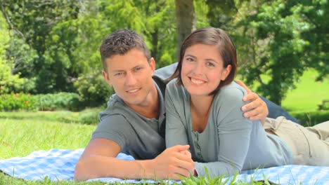 Young-couple-lying-on-the-grass