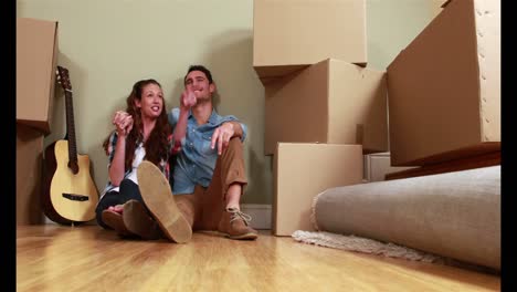 Attractive-young-couple-unpacking-boxes-