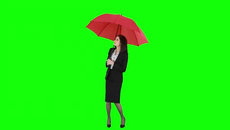Businesswoman-standing-under-umbrella-