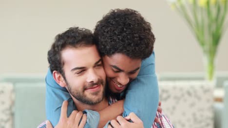 Gay-couple-embracing-in-the-couch