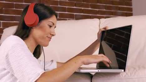 Smiling-woman-using-laptop-