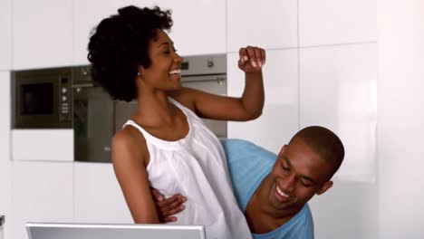 Happy-man-carrying-woman-in-the-kitchen-