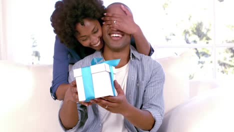 Woman-offering-gift-to-his-boyfriend
