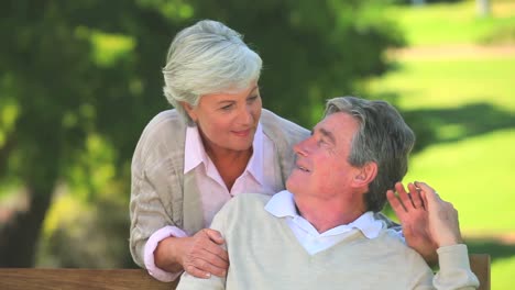 Elderly-couple-talking-while-sitting-on-a-bench