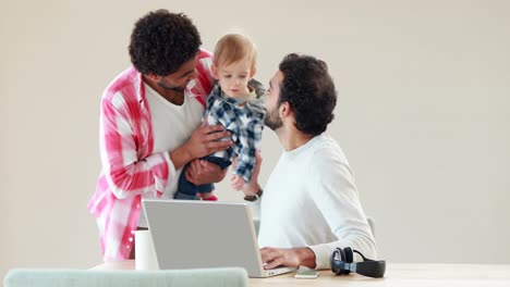 Gay-smiling-couple-with-their-kid