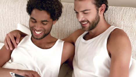 Gay-couple-relaxing-in-the-bed