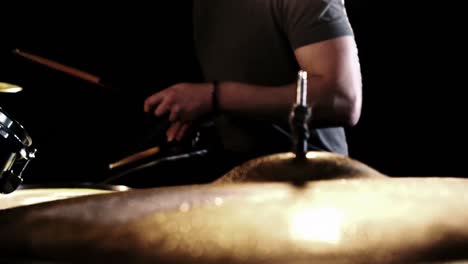 Close-up-of-man-playing-drums