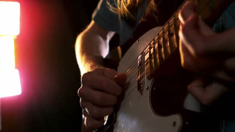 Close-up-of-man-playing-electric-guitar