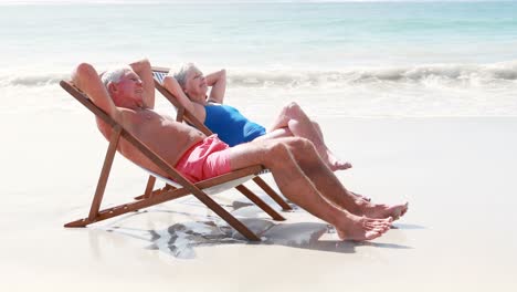 Retired-old-couple-lying-on-deckchair