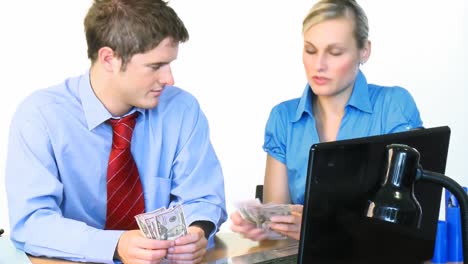 Businessman-and-businesswoman-counting-dollars