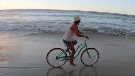 Woman-cycling-at-beach