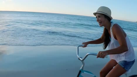 Woman-cycling-at-beach