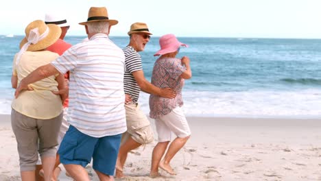 Senior-friends-dancing-on-the-beach--