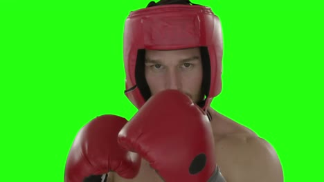 Boxer-punching-in-the-air-against-green-screen-