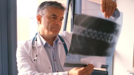 Doctor-checking-a-x-ray-report