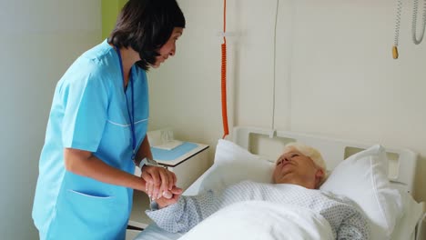 Nurse-consoling-senior-patient-with-doctor