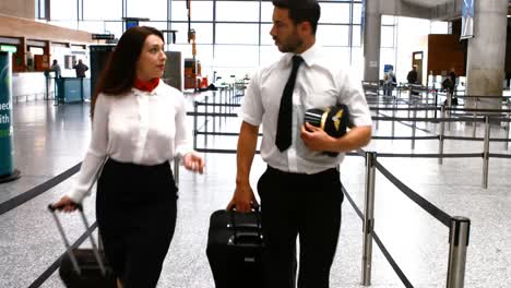 Pilot-and-female-flight-attendant-walking-with-luggage