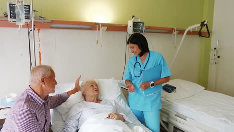 Senior-couple-interacting-with-female-doctor
