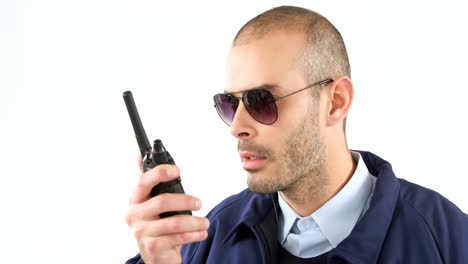 Security-guard-talking-on-walkie-talkie