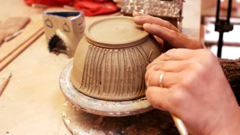 Close-up-of-potter-carving-pot