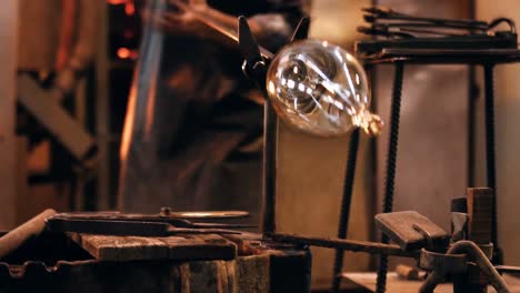 Mid-section-of-Glassblower-shaping-a-molten-glass
