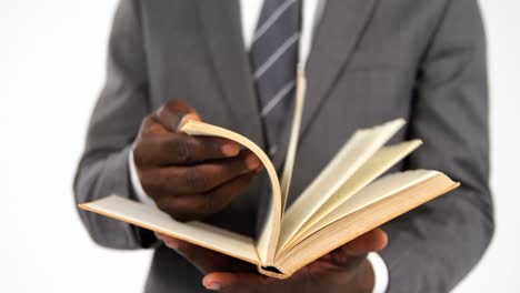 Businessman-flipping-pages-of-a-book