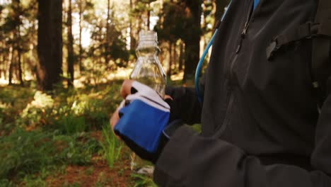 Male-mountain-biker-drinking-water-in-the-forest