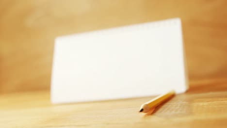 Close-up-of-blank-spiral-calendar-with-pencil