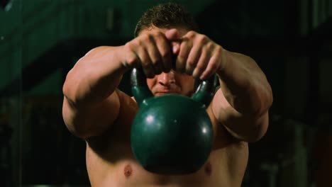 Muscular-man-lifting-kettle-bell